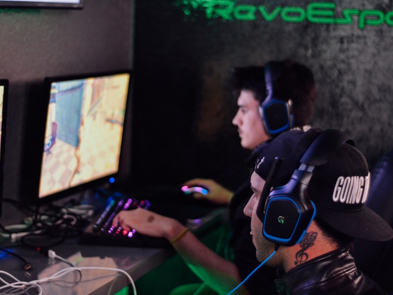 Living-wall greenery behind rows of gaming PCs