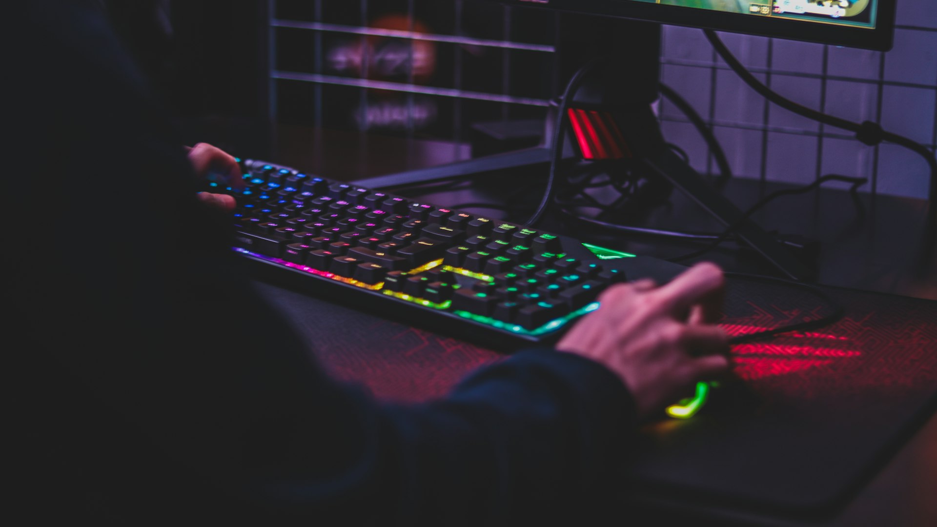 Green, plant-filled gaming lounge with timber beams and glowing battlestations